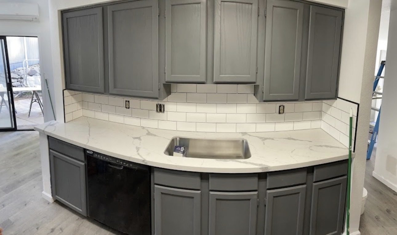 Completed kitchen remodeling project with cabinetry and tile finishes