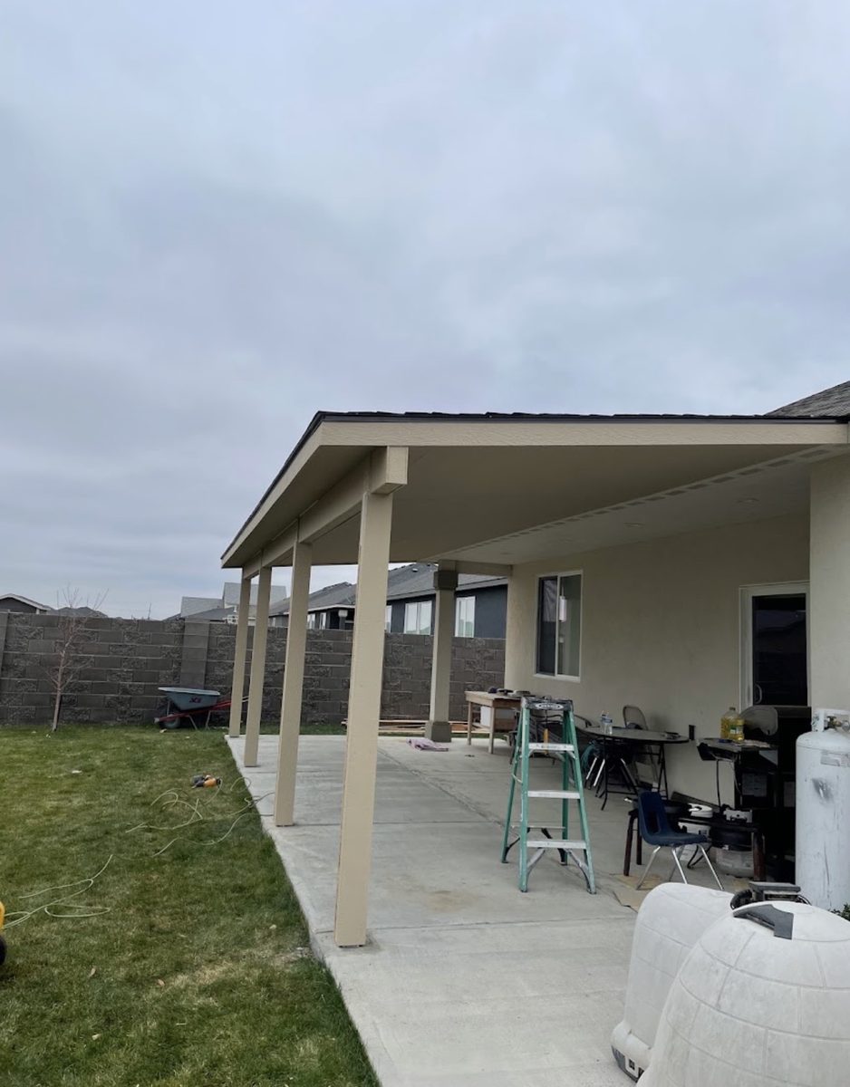 New covered porch addition with an outdoor living area beside a home